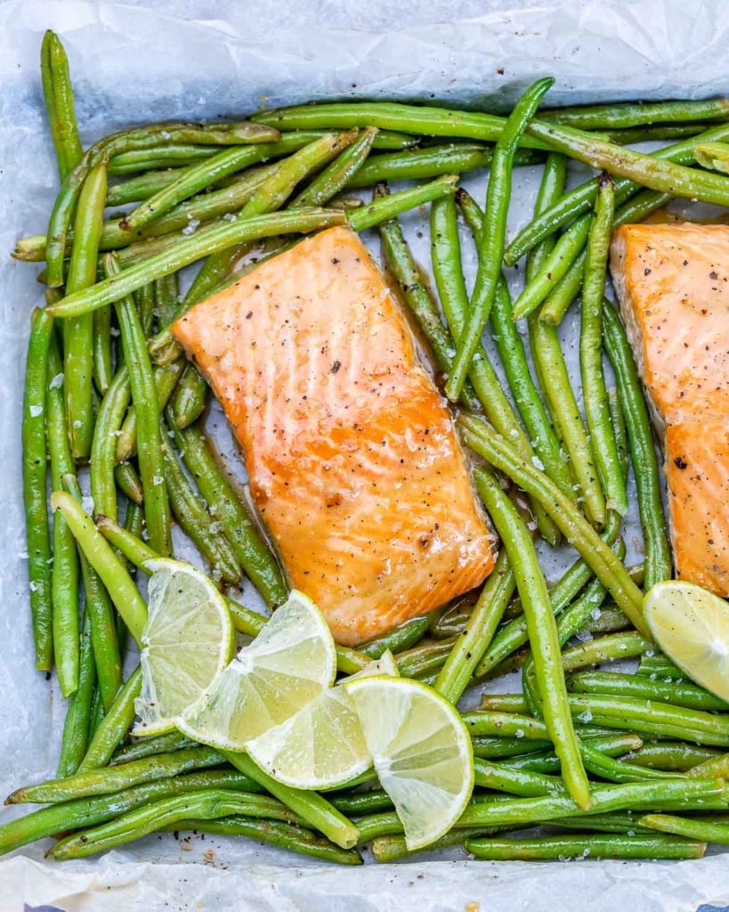 two salmon filets on sheet pan with green beans and lime