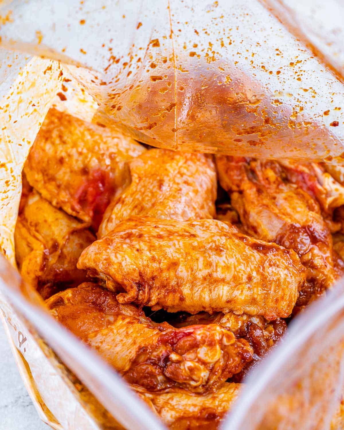 Chicken wings in Ziplock bag with seasonings and oil. 
