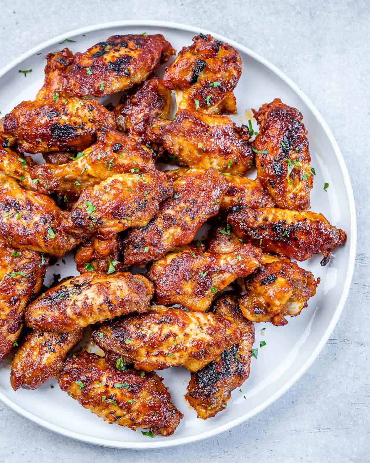oven baked chicken wings with honey garlic sauce on white plate