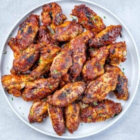 top view baked chicken wings on a white plate