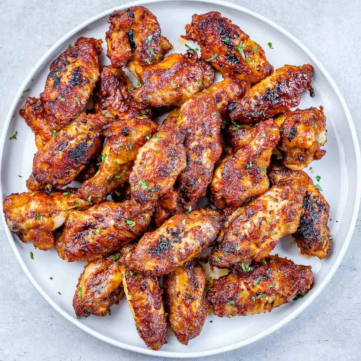 top view baked chicken wings on a white plate