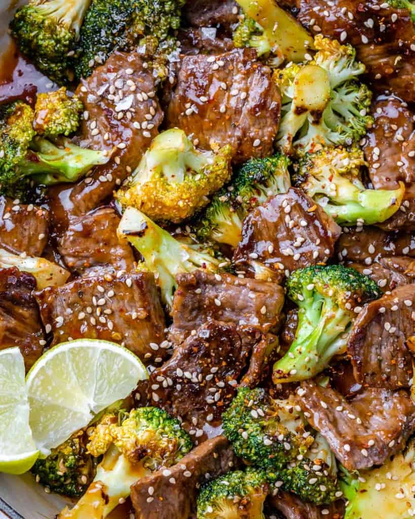 close up beef and broccoli stir fry in a skillet 