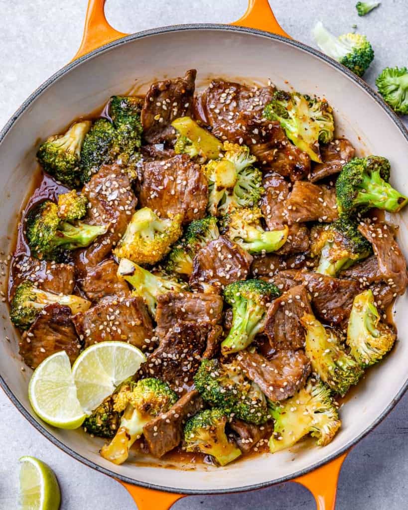 tope view beef and broccoli stir fry in an orange skillet