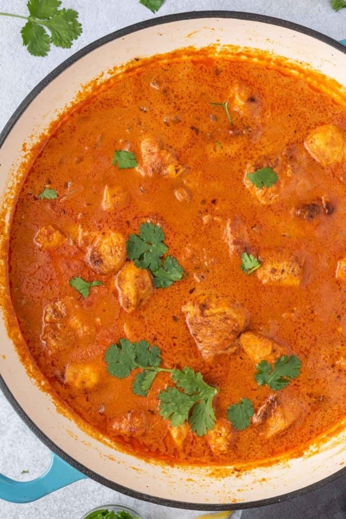 top view of chicken masala in a creamy masala sauce in a pot