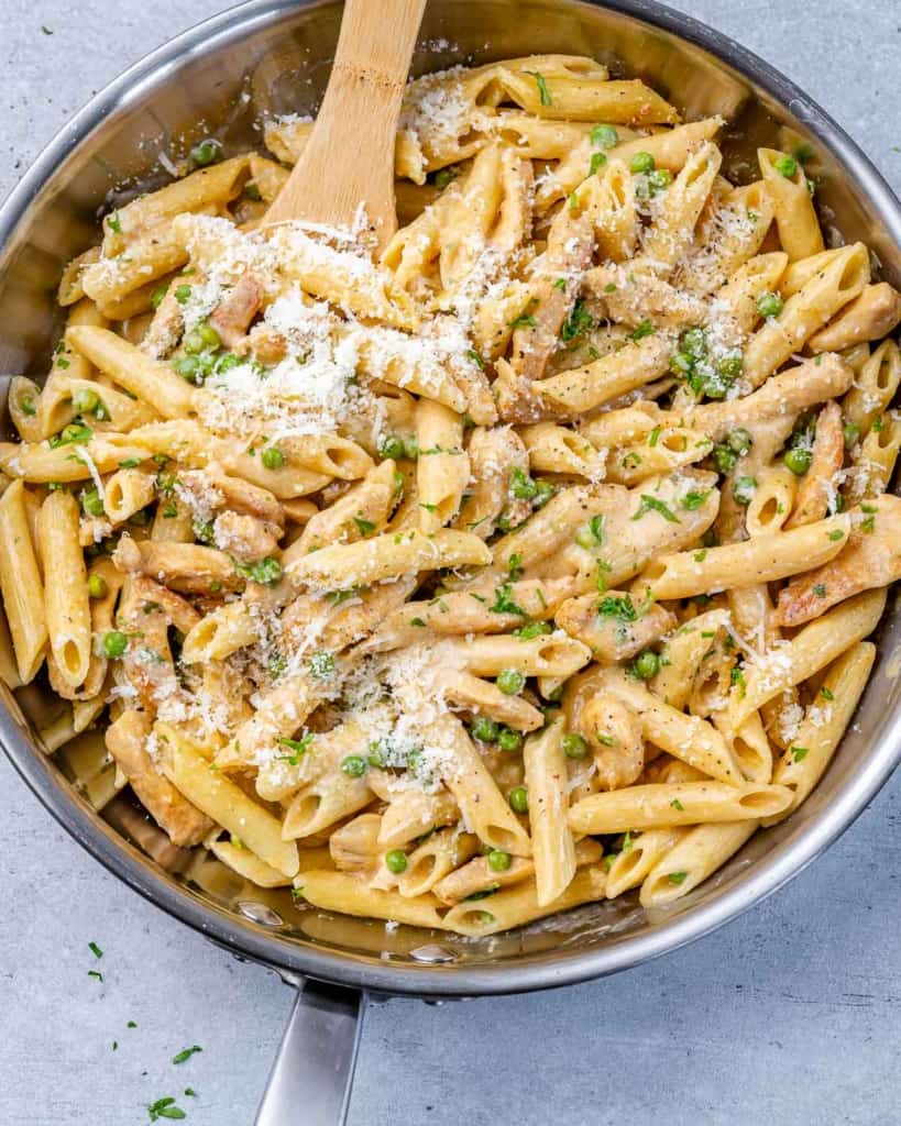 wooden spoon in a chicken and pasta skillet