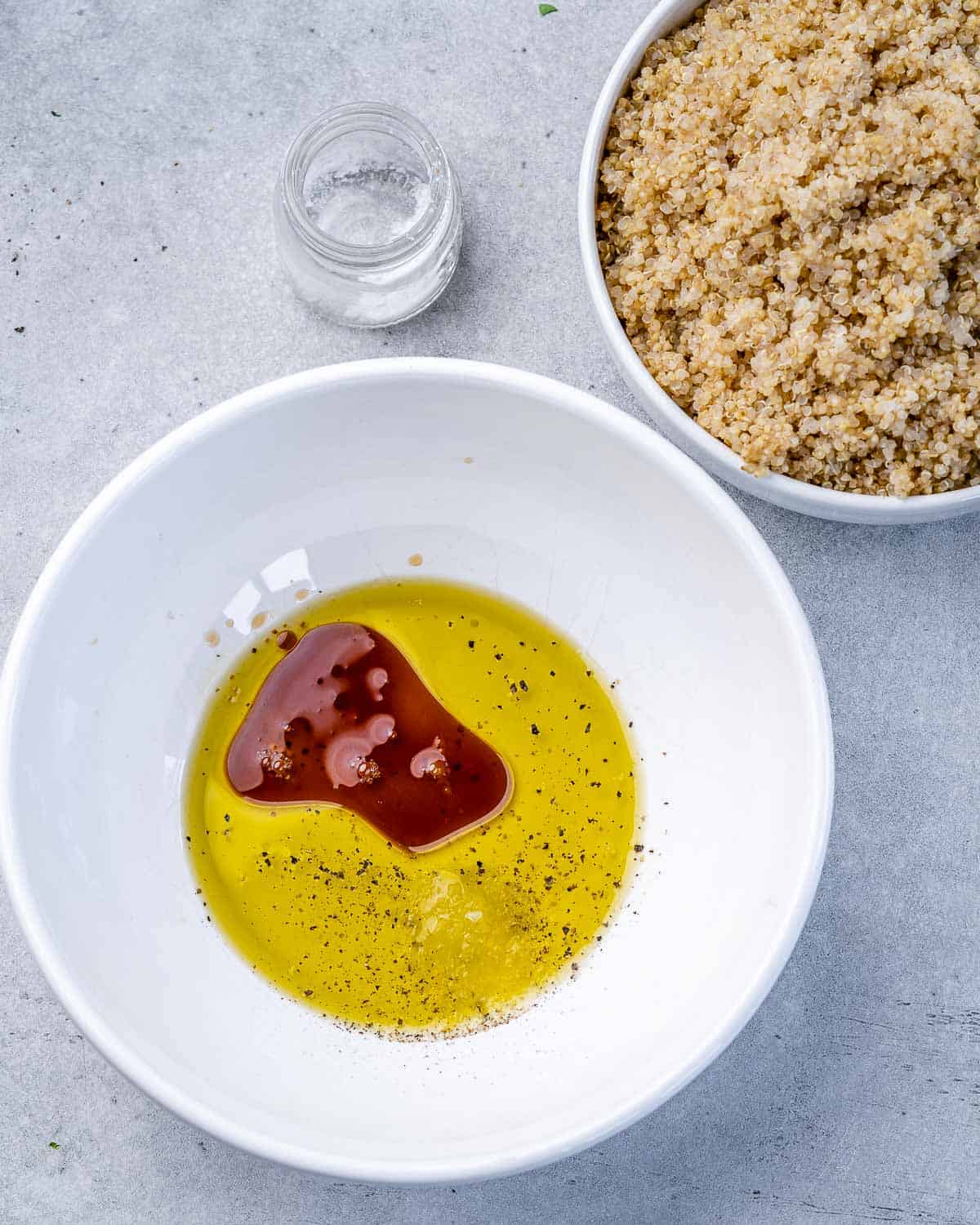 Mediterranean salad dressing ingredients in a circular white bowl. 