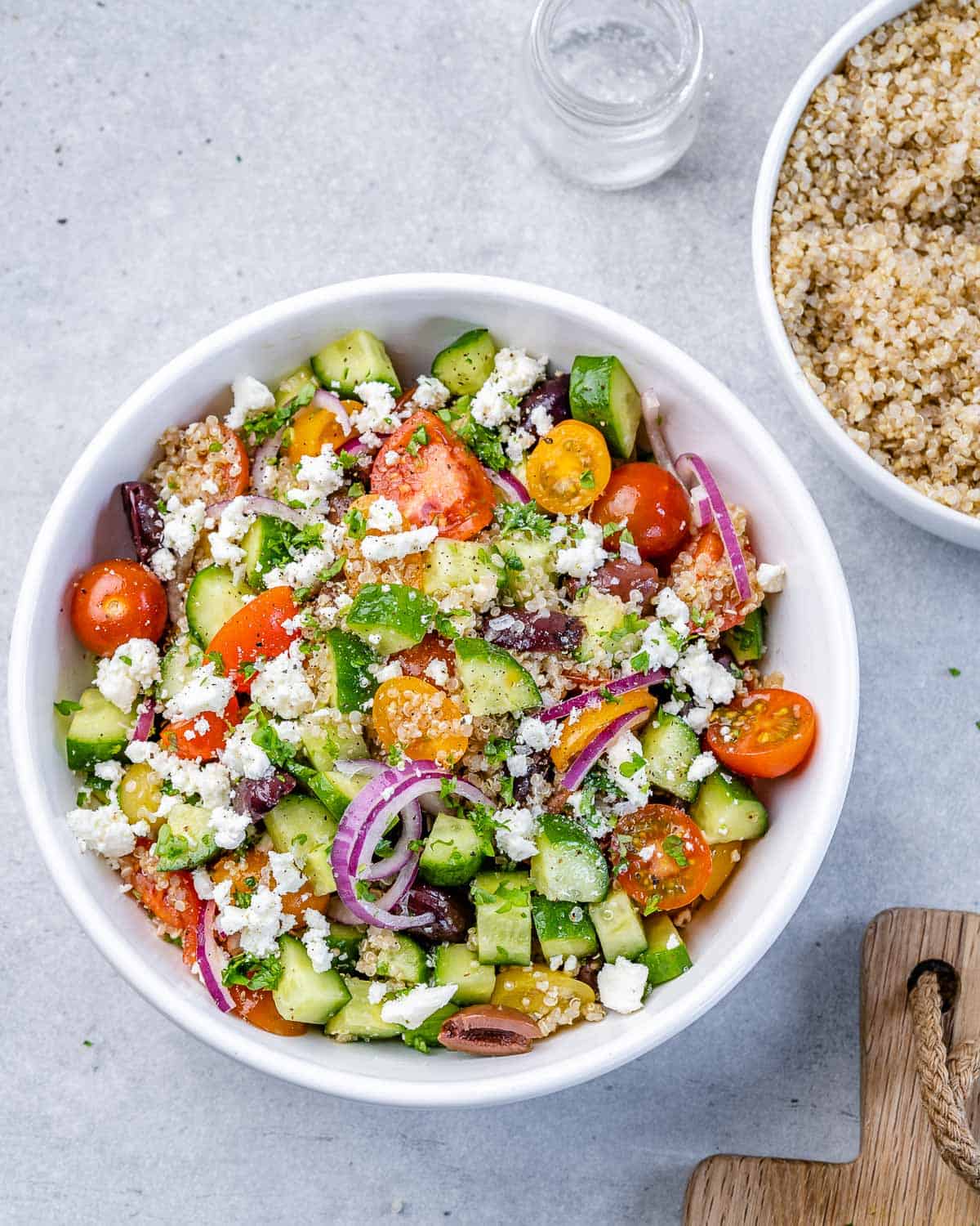 Overhead shot of quinoa salad in circular white serving bowl. 