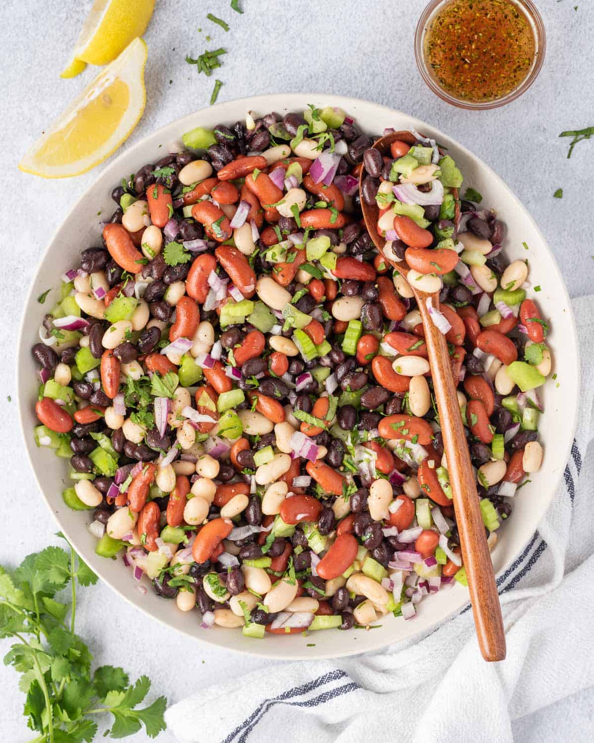 one bowl of three beans salad with cilantro and lemon