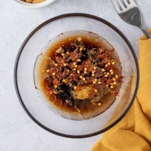 dressing for cucumber salad in a small clear bowl.
