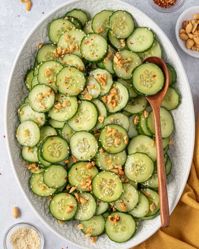 top view asian sliced cucumber salad in a white dishd