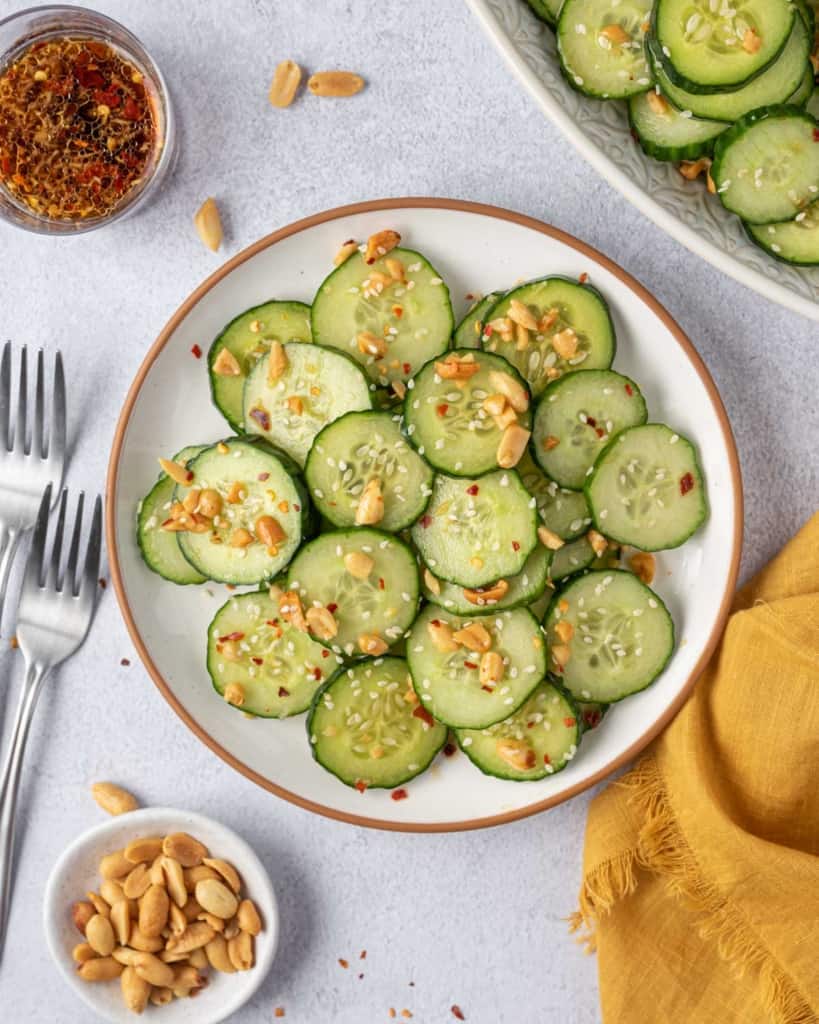 top view of asian cucumber salad in a round white plate