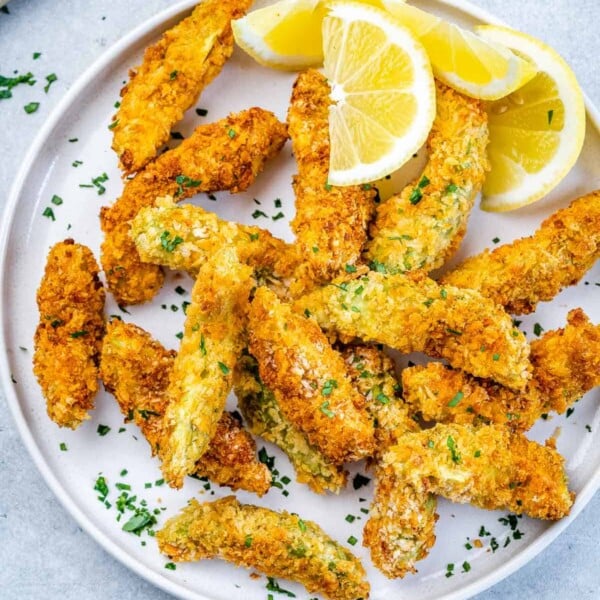 top view of baked avocado fries on a white plate