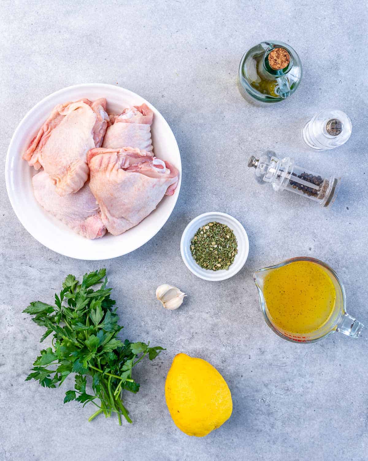chicken thighs, olive oil, lemon, parsley, salt, pepper, garlic, Italian seasoning for baked chicken thighs recipe