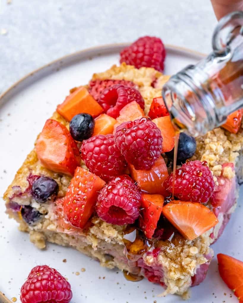 maple syrup being poured over slice of baked oatmeal 