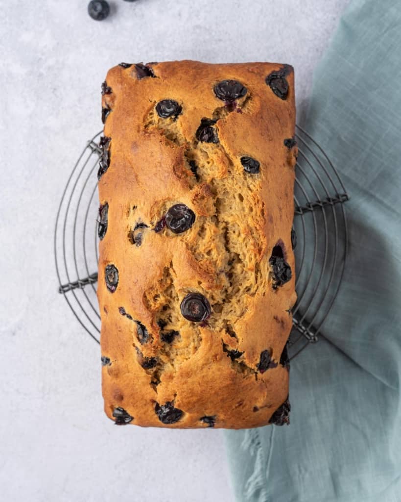 blueberry banana bread baked over a cooling wrack