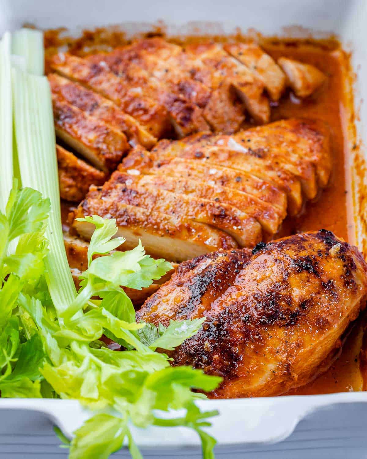 front view of buffalo baked chicken breasts with celery 