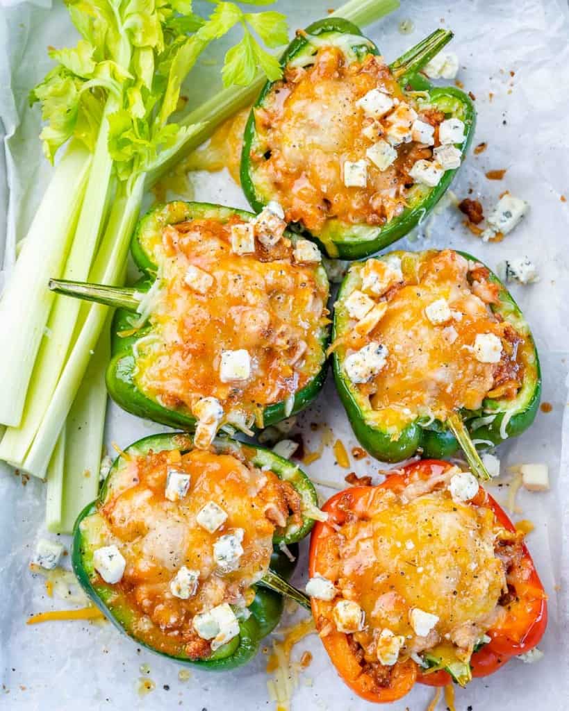 top view of 5 stuffed peppers on a plate 