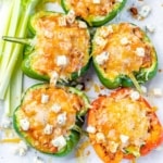 Top view of chicken stuffed peppers topped with blue cheese crumble