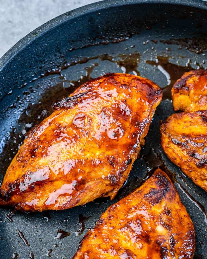 Chicken cooking in a pan.
