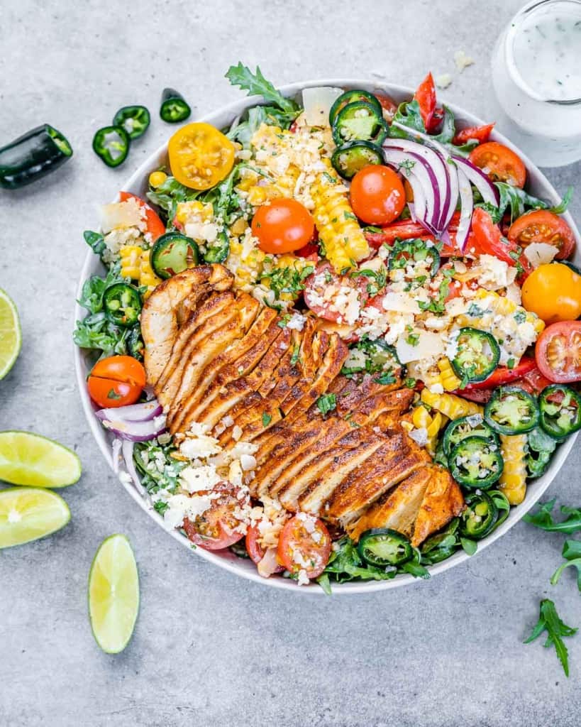 top view chicken salad in a bowl with lime wedges on the side 