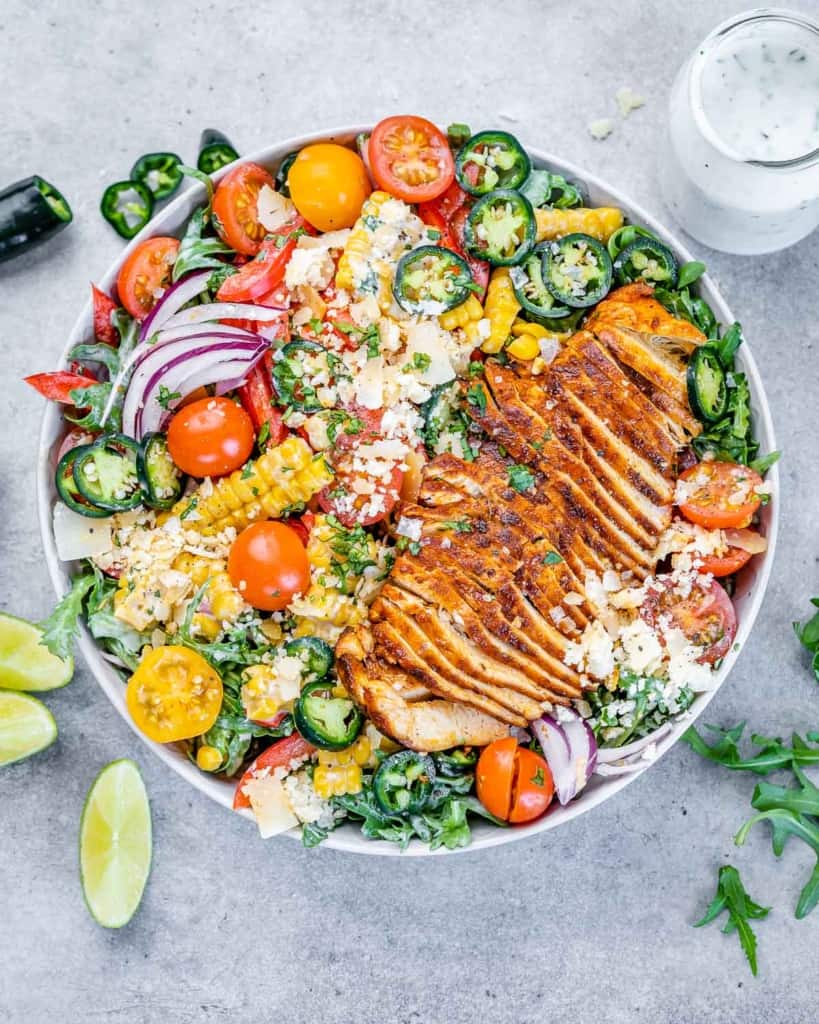 top view of chicken arugula salad in a bowl