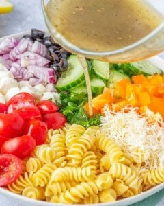 dressing being added over the salad.