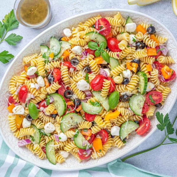 a white dish filled with Italian Pasta Salad.