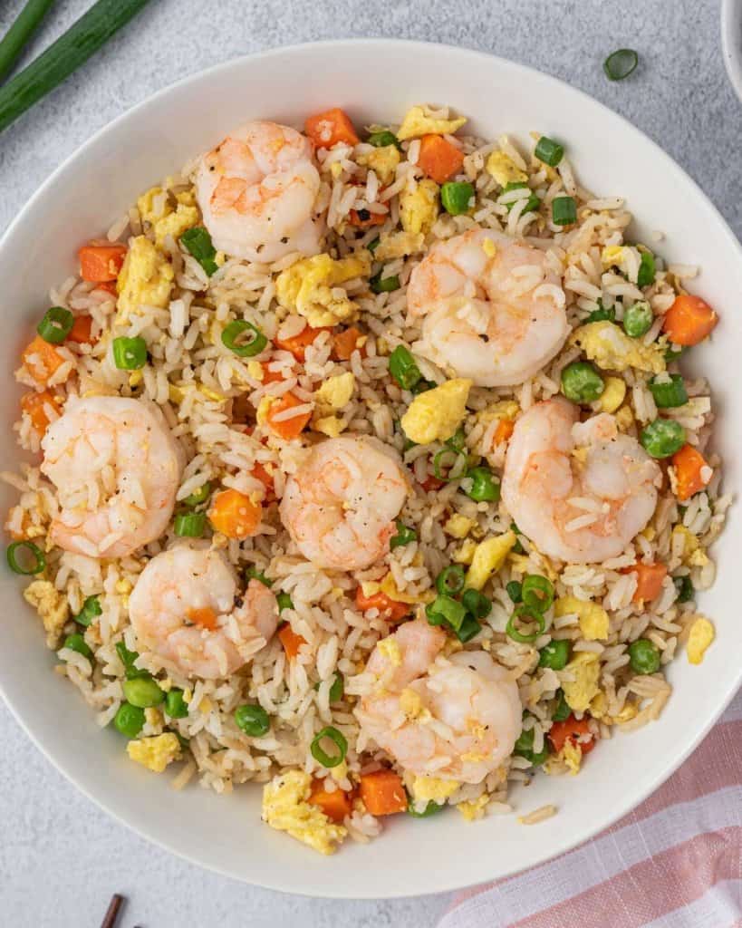 shrimp fried rice in a white plate 