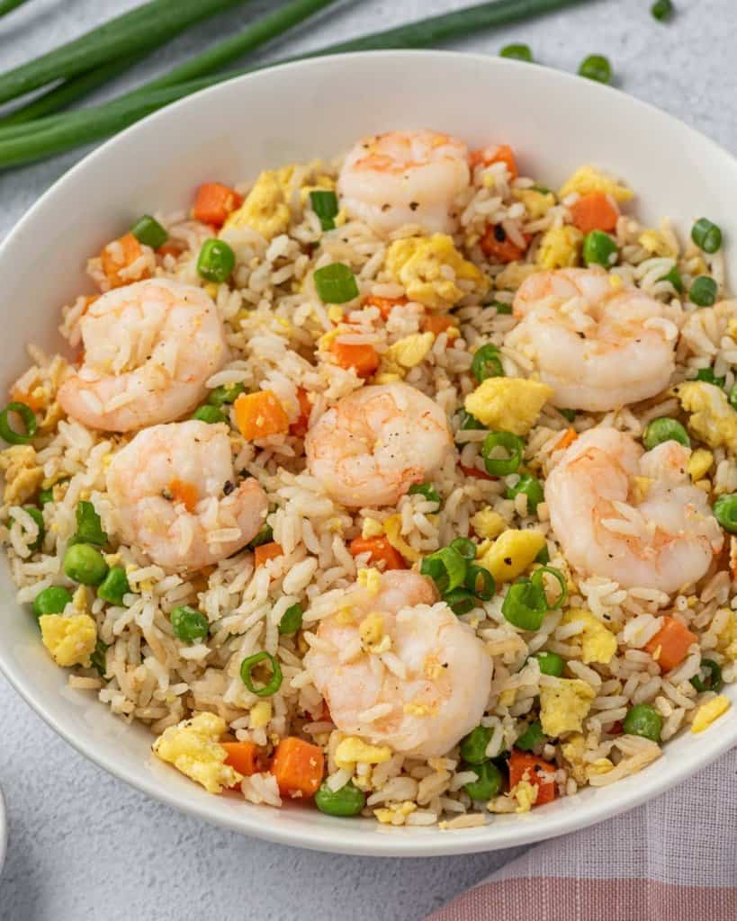 side shot of shrimp and fried rice on a plate 