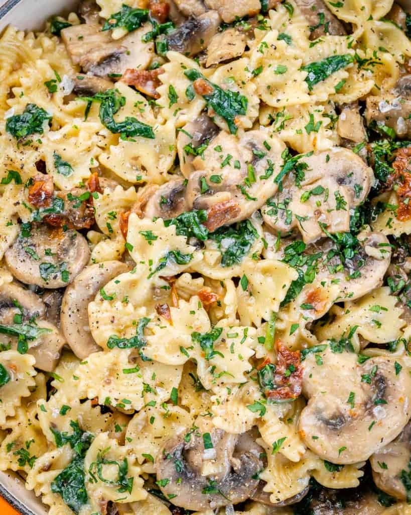close up mushroom and spinach pasta 