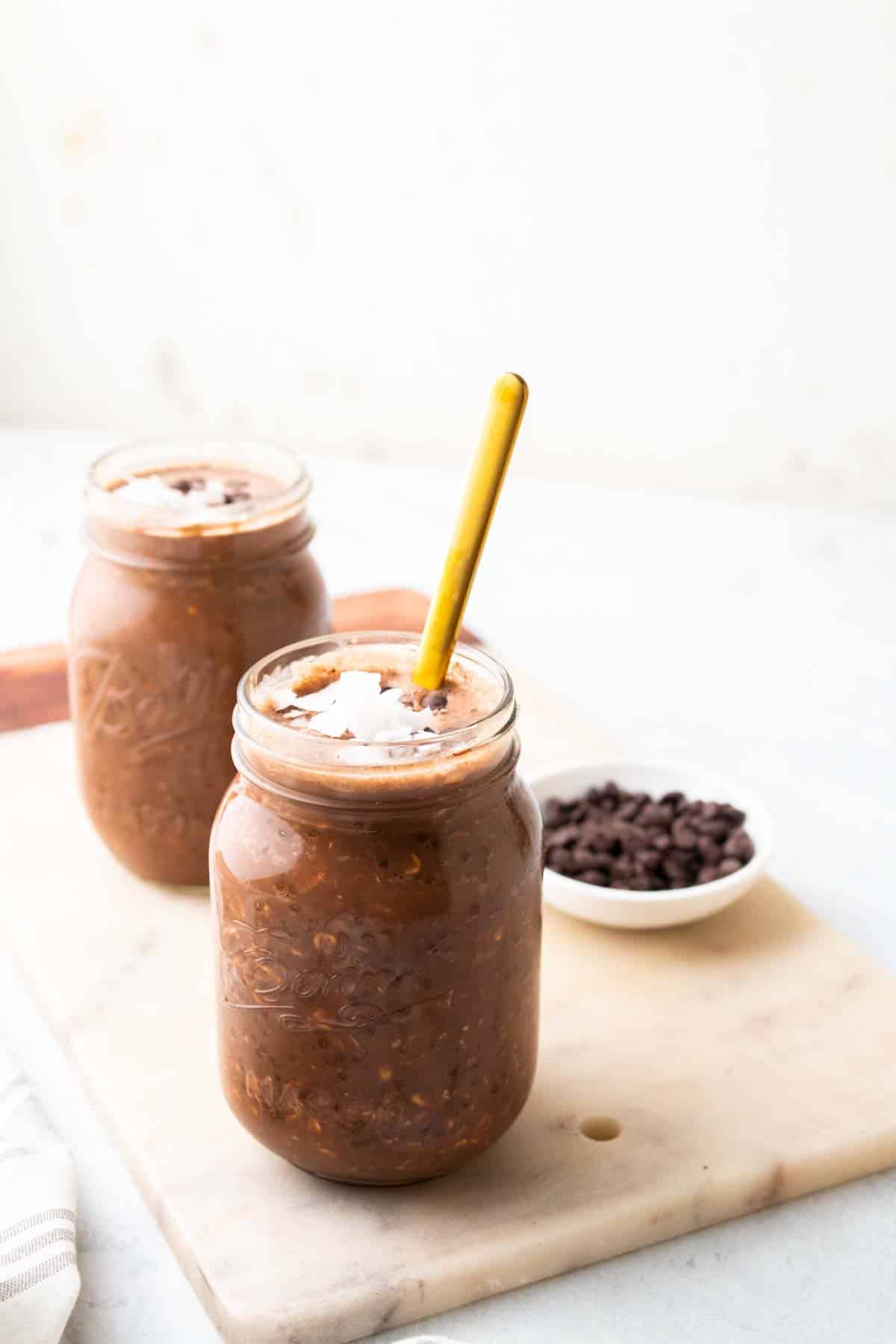 two jars of chocolate pb overnight oats with spoon
