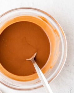 melted peanut butter with chocolate in a clear bowl