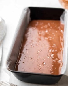 side shot of chocolate peanut butter bar in the pan before it sets