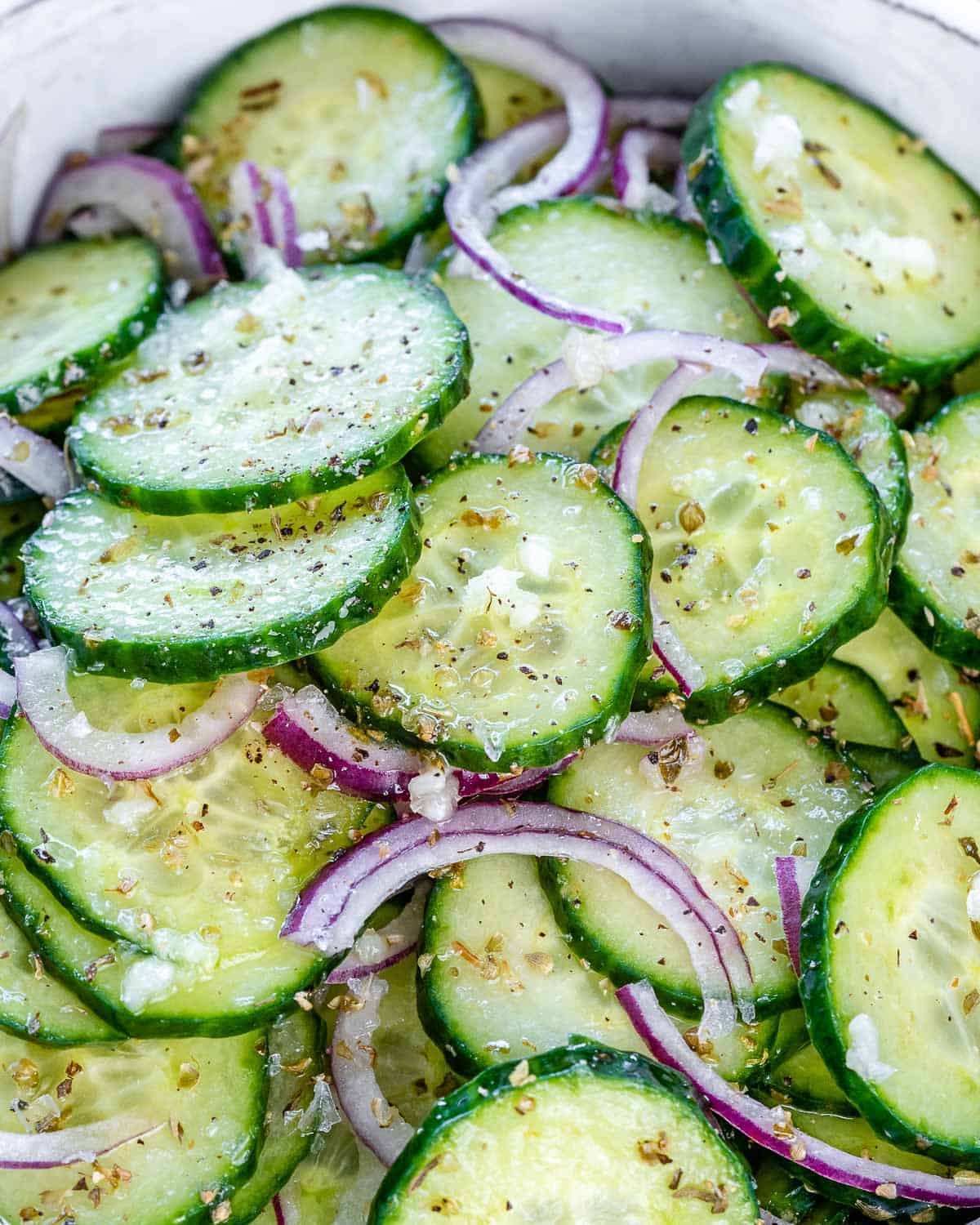 cucumber onion salad in bowl with Italian dressing
