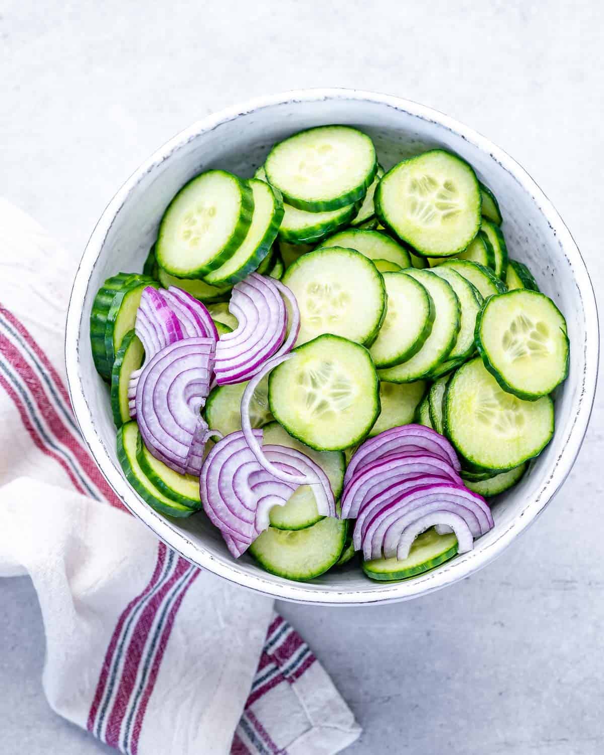 red onions and cucumber slices in bowl