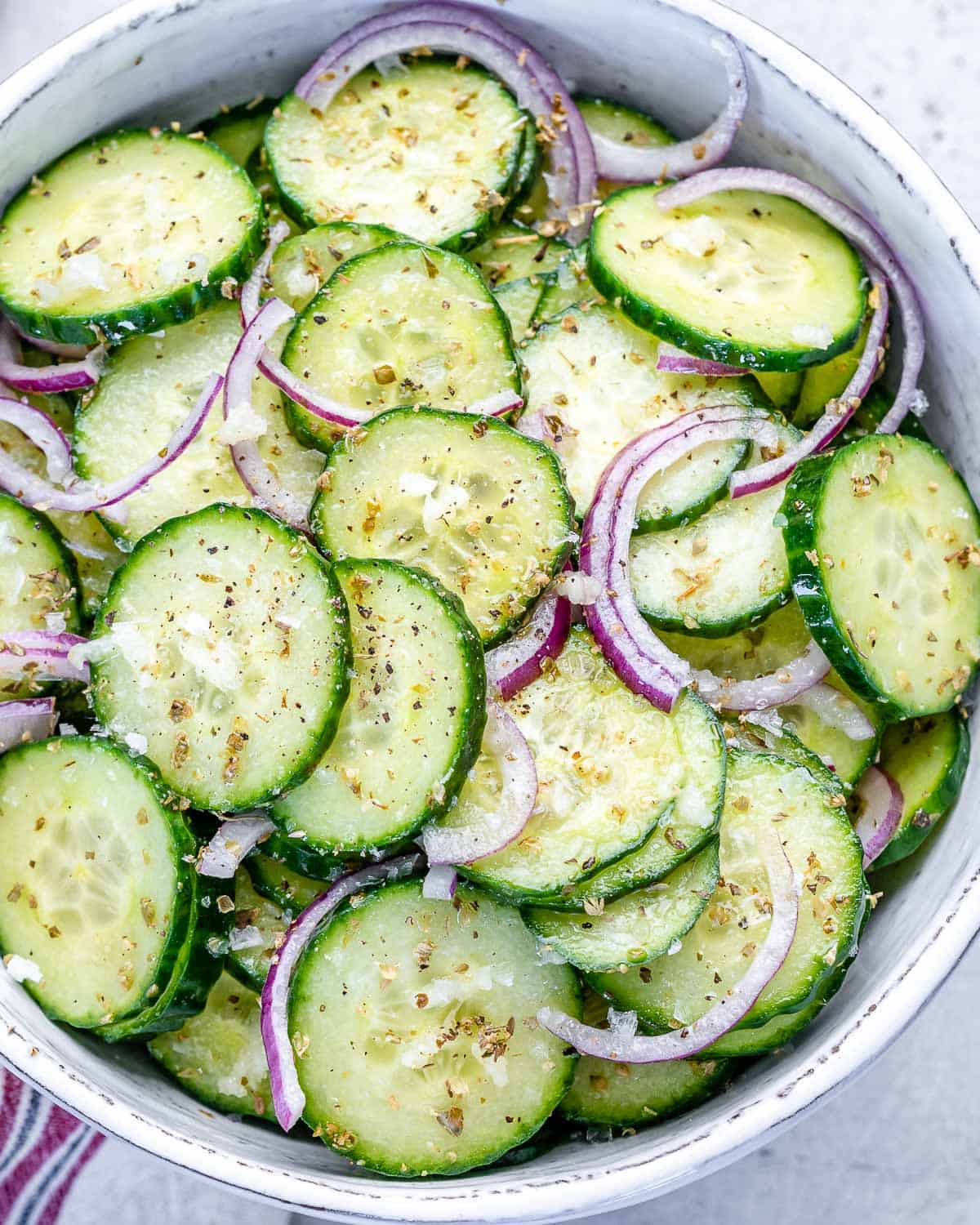 top view cucumber salad in a white bowl