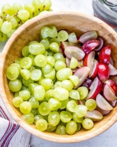 sliced grapes in a brown wooden bowl