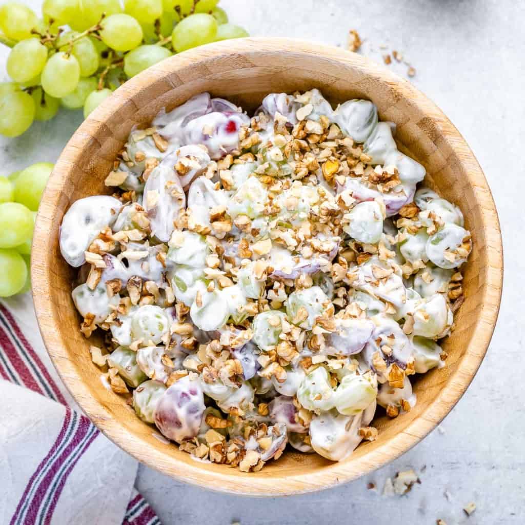 top view grape salad in a round wooden bowl