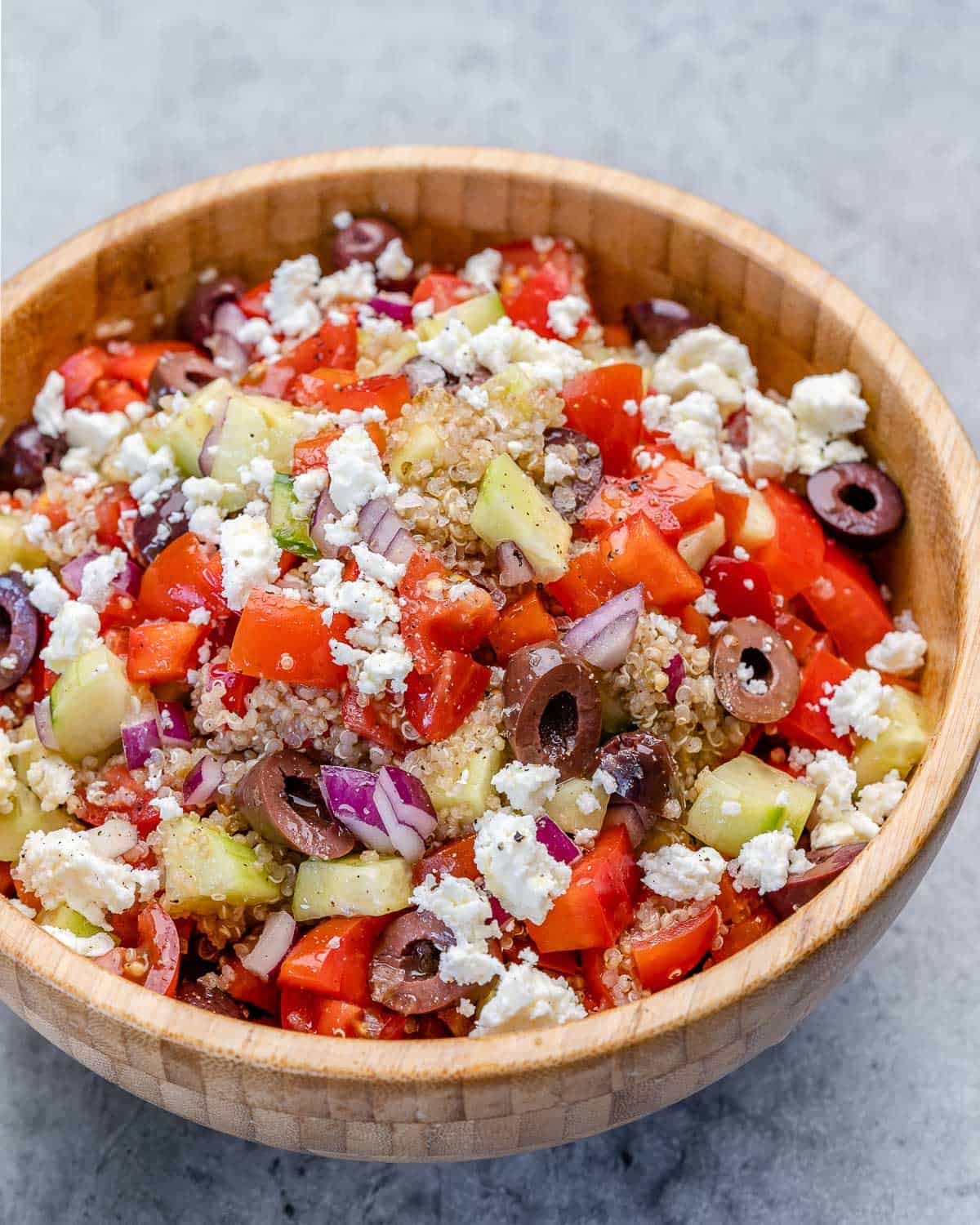 side view of mediterranean quinoa salad in bowl with feta 
