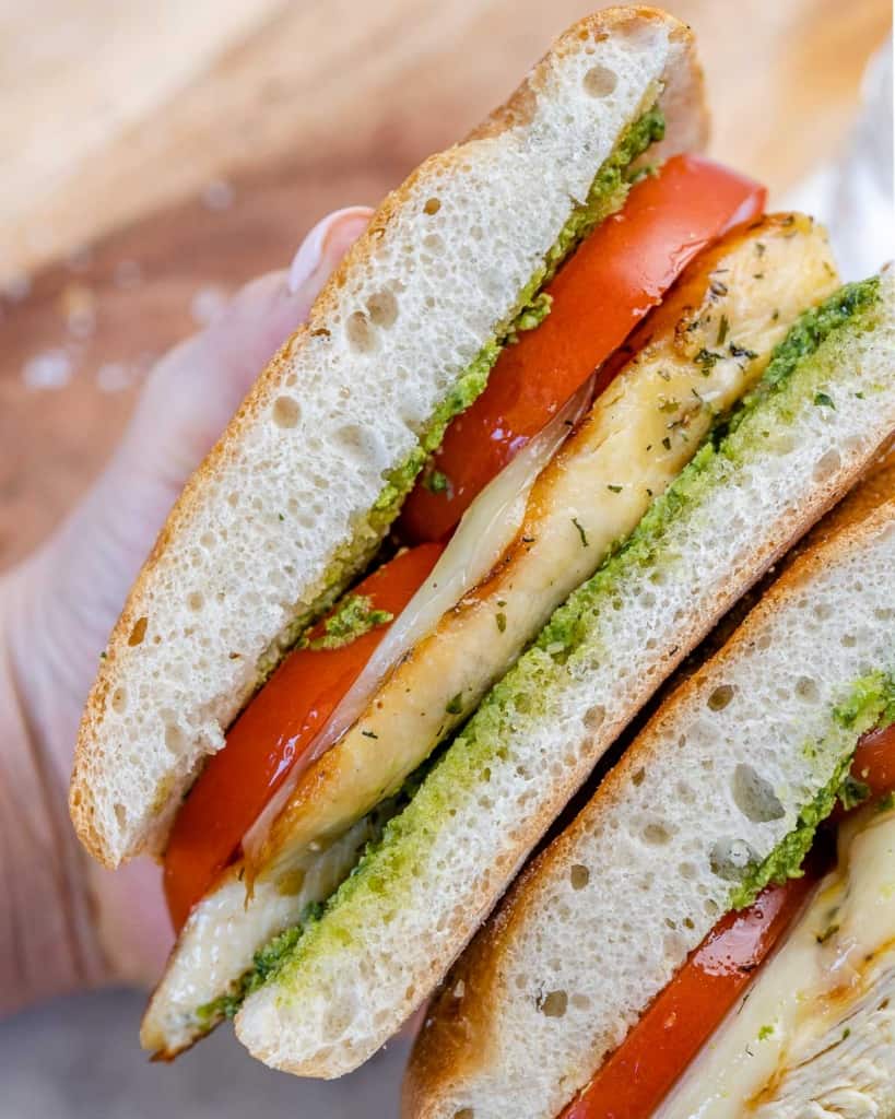 top view of two half sandwich with tomato pesto and chicken breast