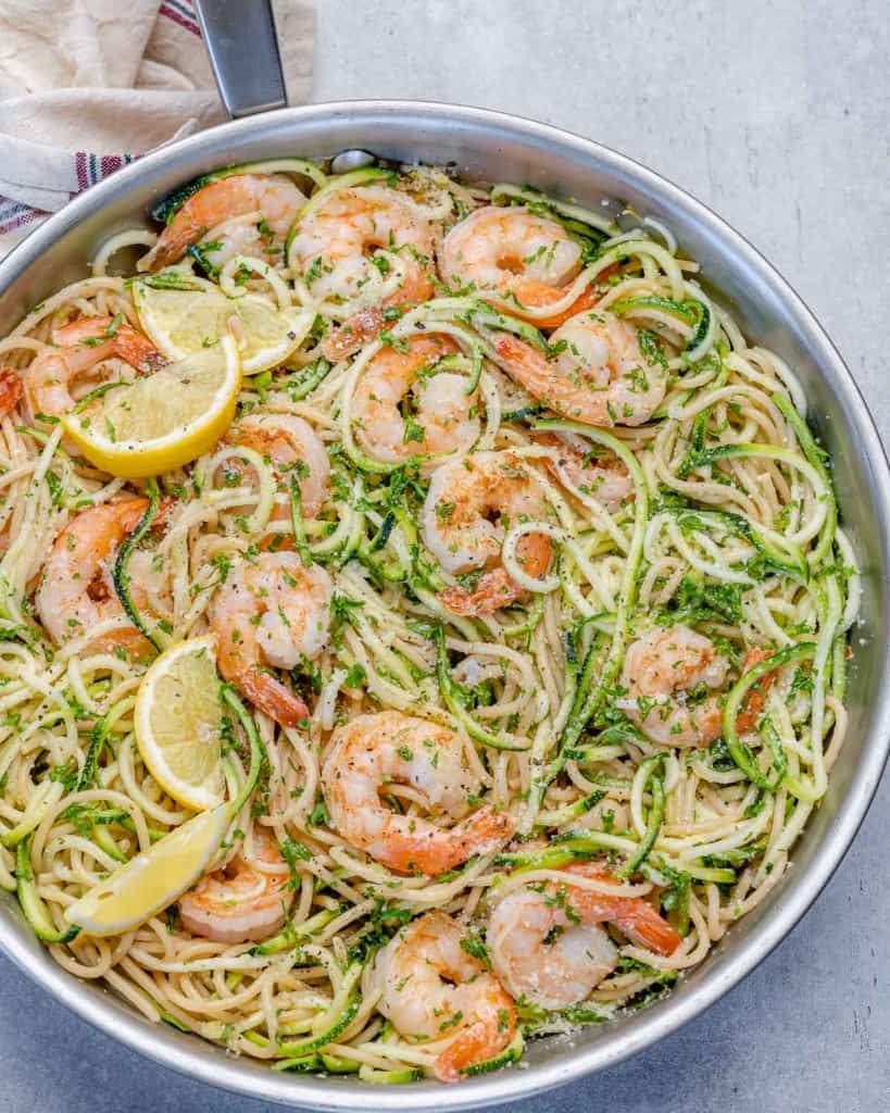 one pan of lemon garlic shrimp pasta with zoodles and parmesan cheese