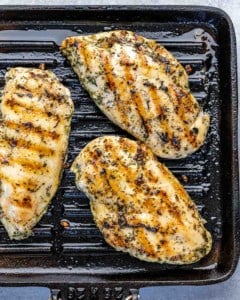 top view of 3 grilled chicken breast on a grill pan