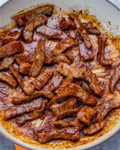 steak strips cooked with fajita seasoning in a skillet