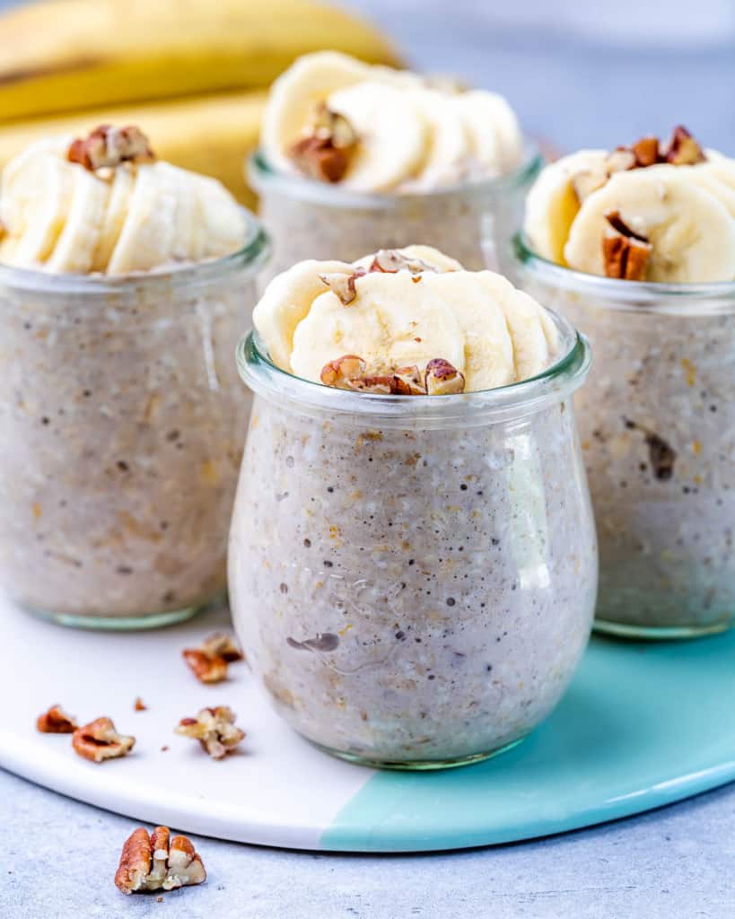 four jars of overnight oats with bananas and pecans