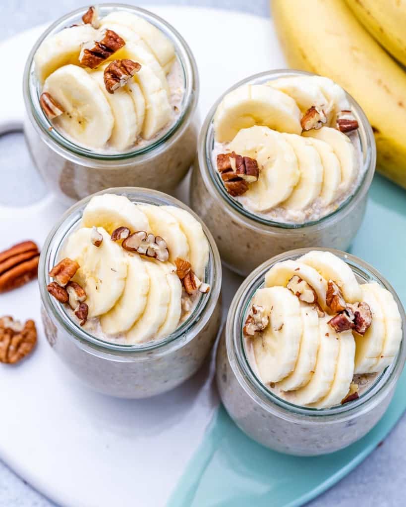 overnight oats with banana and pecans in four jars