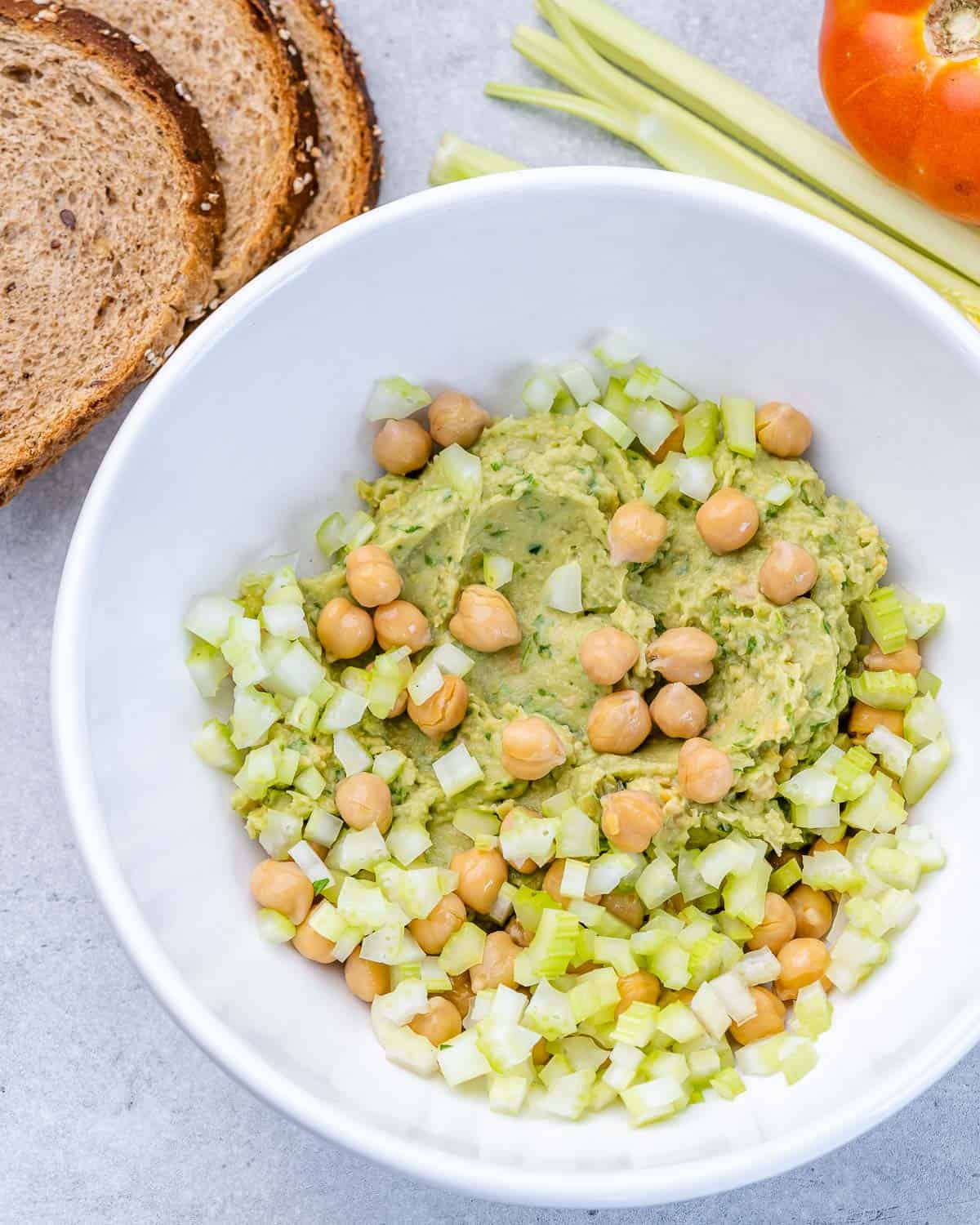 avocado smash in bowl with chickpeas and celery