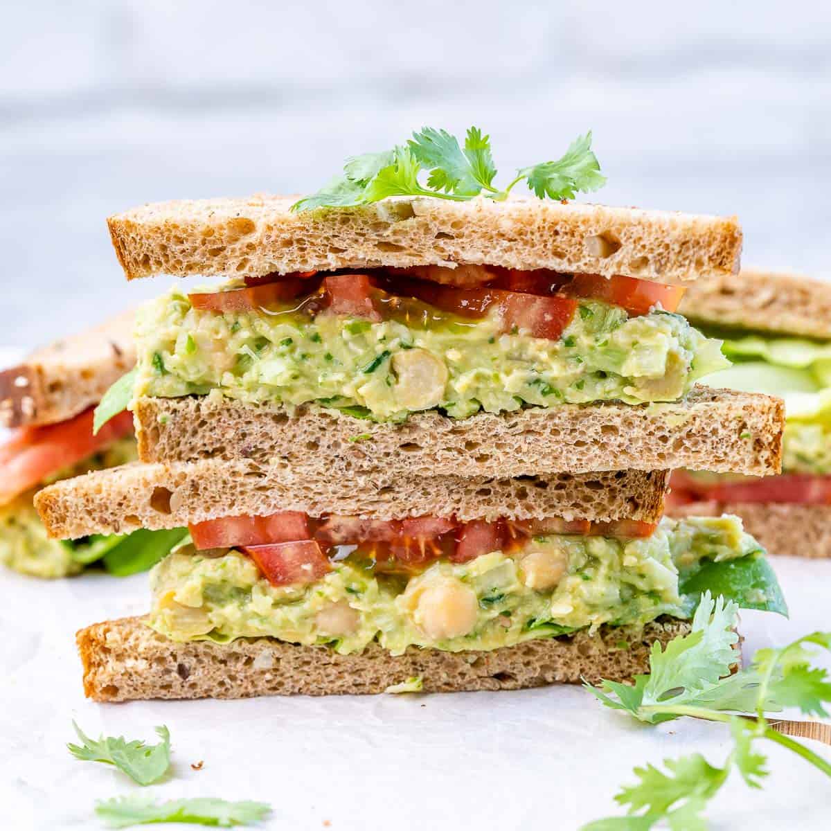 side shot of chickpea and avocado sandwich stacked on each other