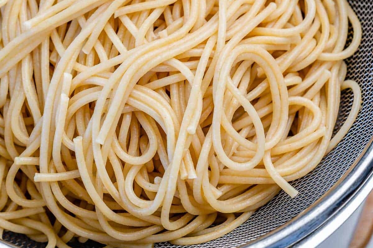 Cooked spaghetti in a colander.