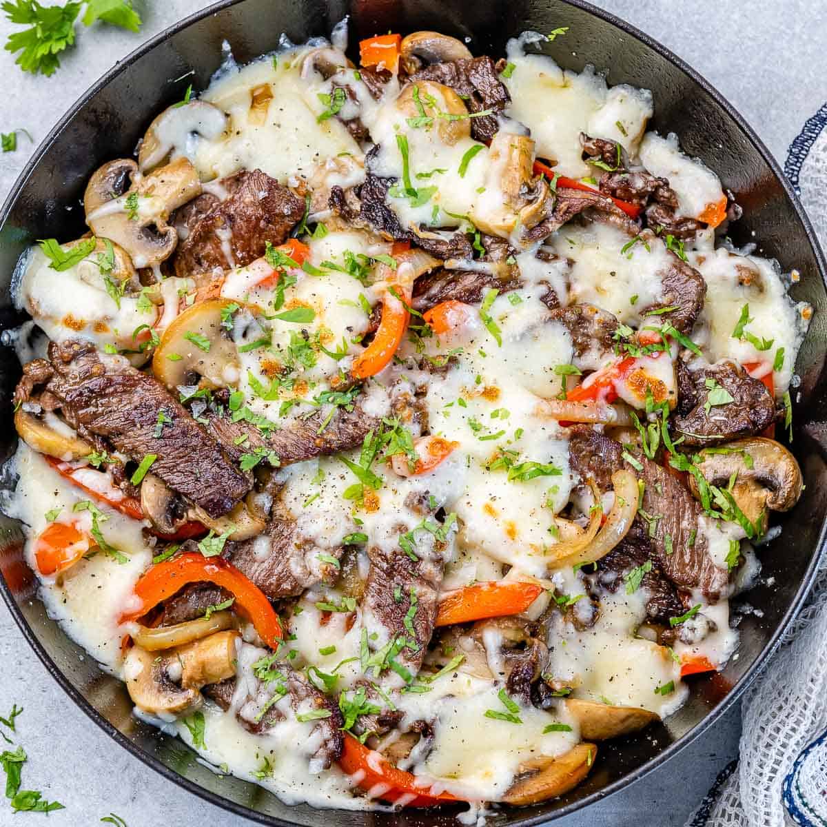 top view cheese steak in a black skillet
