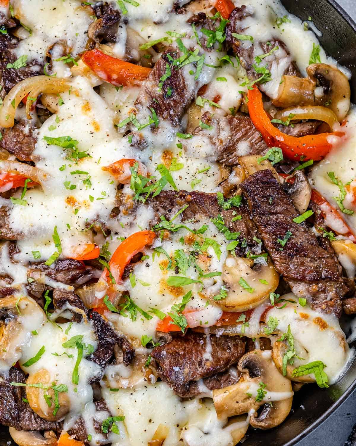 close view of Philly cheese steak recipe in pan with melted mozzarella